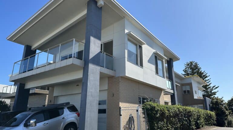 New extrior paint for a house in Dudley on a leafy street.